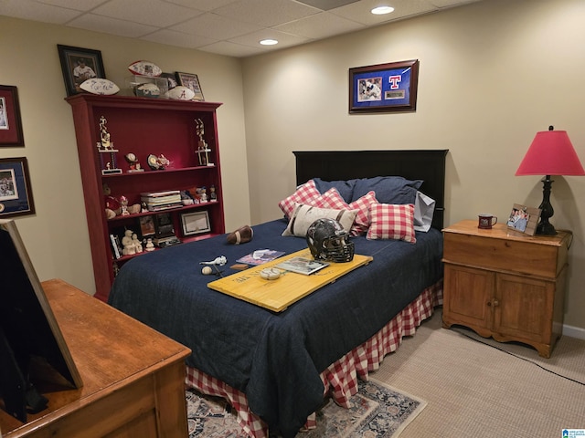 carpeted bedroom with a paneled ceiling