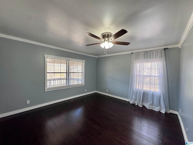 empty room featuring crown molding, dark wood-type flooring, and ceiling fan