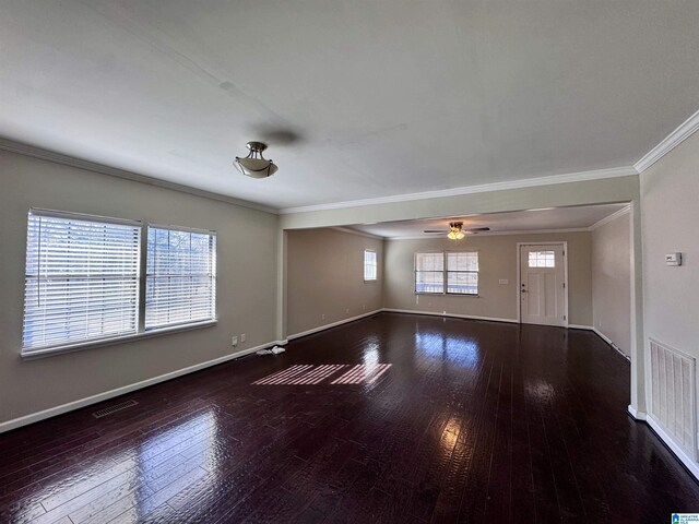 unfurnished living room featuring dark wood-type flooring, ornamental molding, and ceiling fan