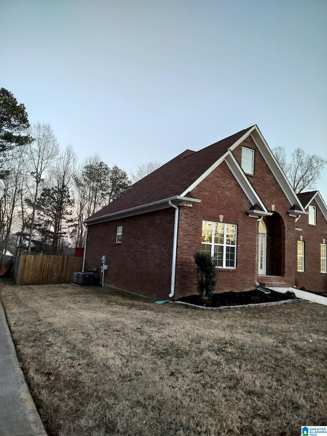 property exterior at dusk with a yard