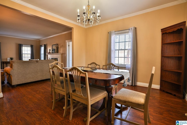 dining space featuring crown molding, a healthy amount of sunlight, dark hardwood / wood-style flooring, and a chandelier