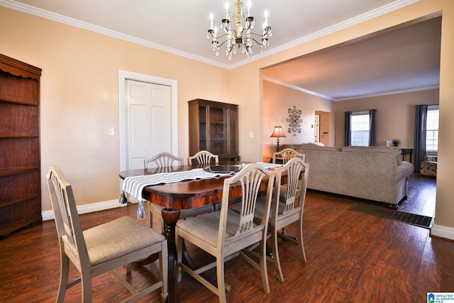 dining space featuring dark wood-type flooring, ornamental molding, and a chandelier