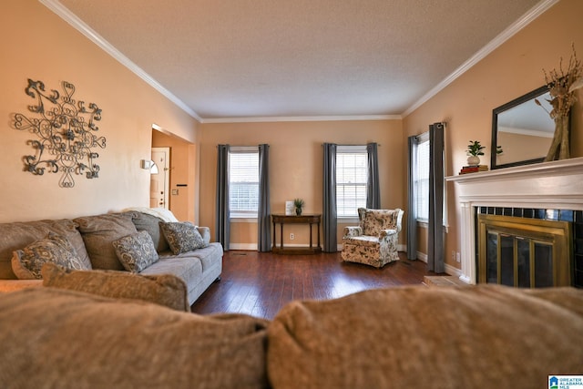 living room with crown molding, dark hardwood / wood-style floors, a tile fireplace, and a textured ceiling