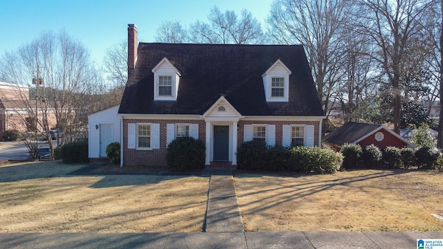 cape cod home with a front lawn