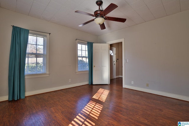 spare room featuring ceiling fan and dark hardwood / wood-style floors