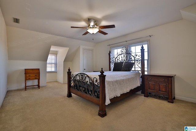 bedroom with ceiling fan, vaulted ceiling, and light carpet