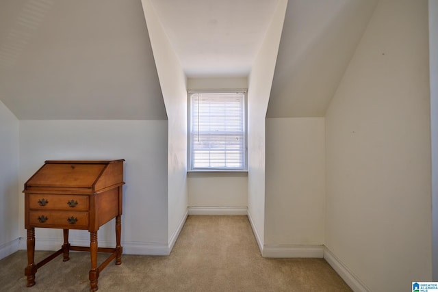 additional living space featuring lofted ceiling and light carpet