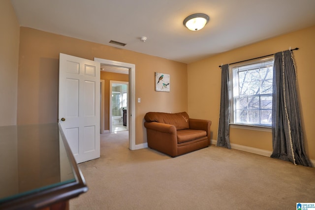 sitting room featuring light colored carpet