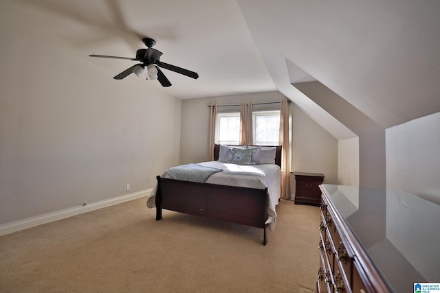 bedroom with ceiling fan, vaulted ceiling, and light carpet