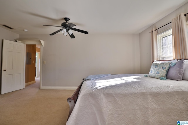 unfurnished bedroom featuring light carpet, electric panel, and ceiling fan