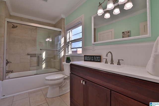 full bathroom featuring tile patterned flooring, bath / shower combo with glass door, vanity, ornamental molding, and toilet