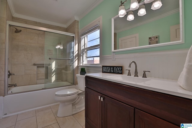 full bathroom featuring crown molding, tile patterned flooring, bath / shower combo with glass door, vanity, and toilet