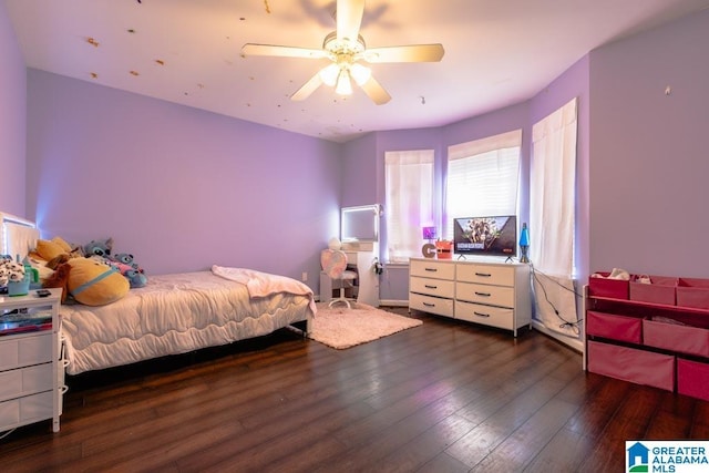 bedroom with dark hardwood / wood-style floors and ceiling fan