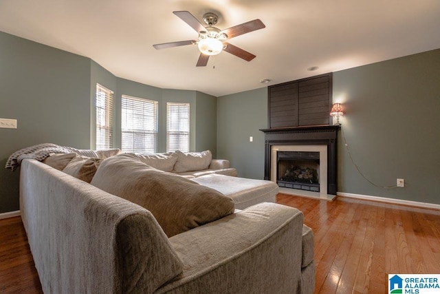 living room with ceiling fan and light hardwood / wood-style flooring