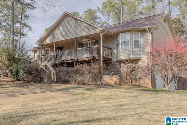 back of house with a wooden deck, ceiling fan, and a lawn