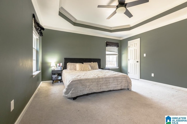 carpeted bedroom featuring crown molding, ceiling fan, and a tray ceiling