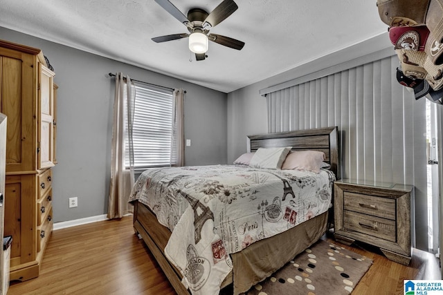 bedroom with light hardwood / wood-style floors and ceiling fan