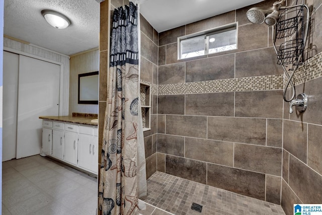 bathroom featuring vanity, a shower with shower curtain, and a textured ceiling