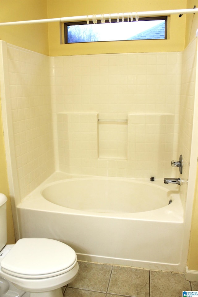 bathroom featuring shower / tub combination, tile patterned floors, and toilet