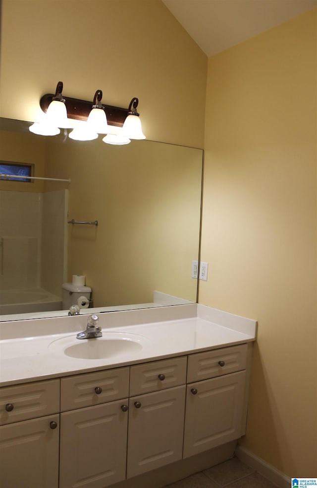 bathroom featuring vanity, tile patterned floors, and toilet