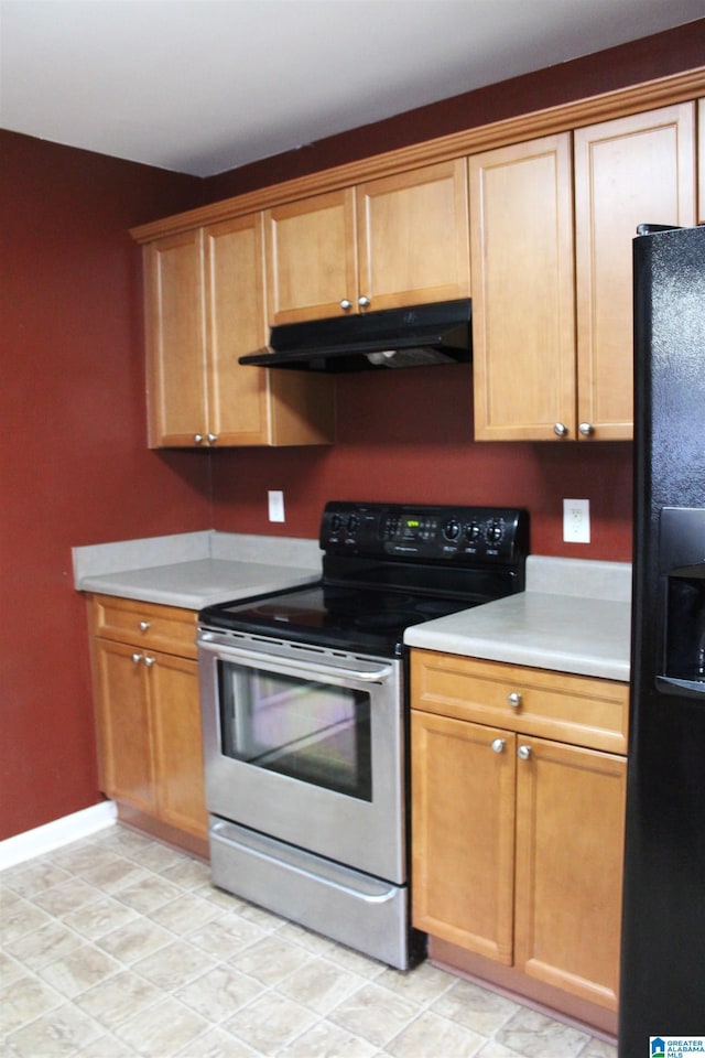 kitchen with black fridge and electric range