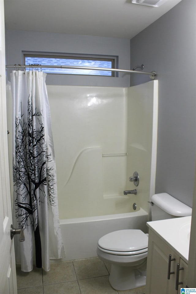 full bathroom featuring vanity, shower / tub combo with curtain, tile patterned floors, and toilet