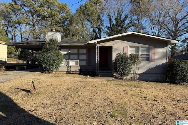 view of front of property with a front lawn and a carport