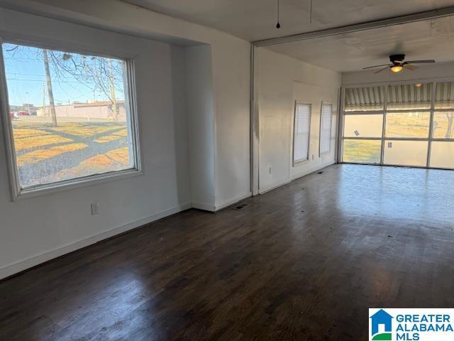 interior space with dark hardwood / wood-style floors and ceiling fan