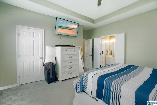 carpeted bedroom featuring ceiling fan and ensuite bath