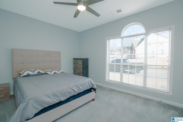 bedroom with ceiling fan and light colored carpet