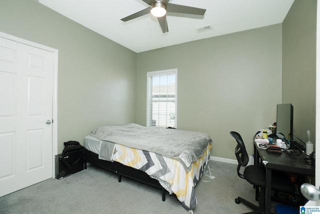 bedroom with ceiling fan and light carpet