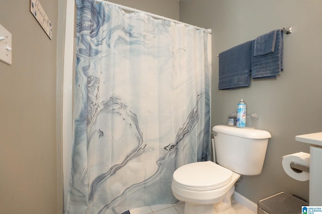 bathroom with tile patterned flooring, curtained shower, and toilet