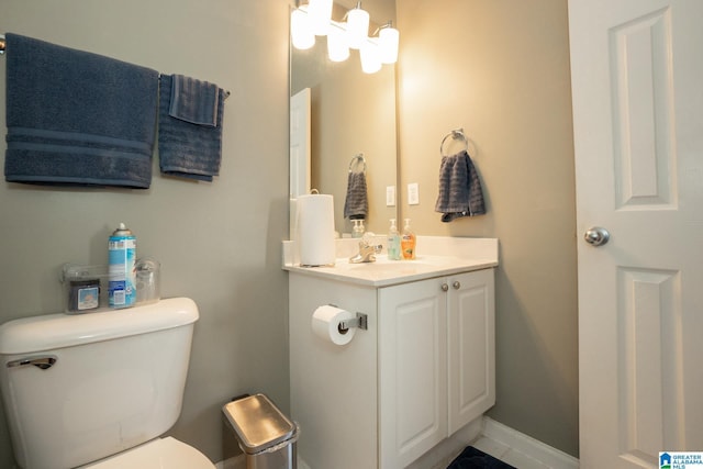 bathroom with vanity, a notable chandelier, and toilet