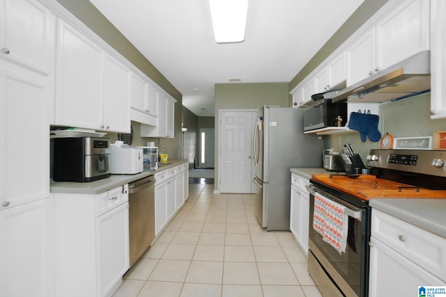 kitchen featuring light tile patterned floors, white cabinets, and appliances with stainless steel finishes