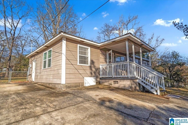 view of side of home with covered porch