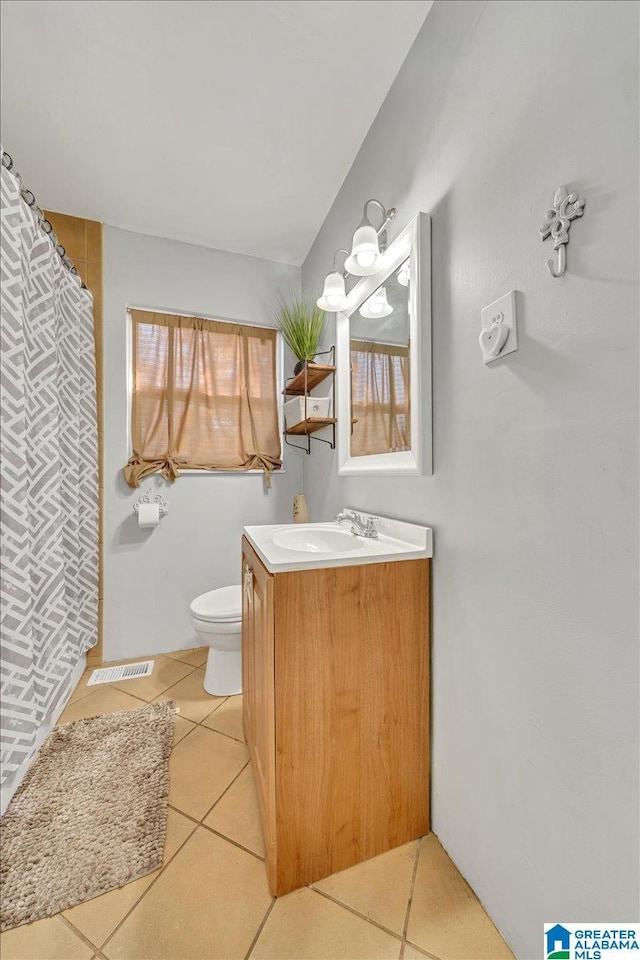 bathroom with vanity, tile patterned floors, and toilet