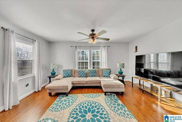 living room with ceiling fan, light hardwood / wood-style floors, and a healthy amount of sunlight