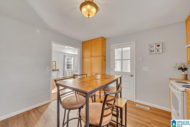 dining area with light wood-type flooring