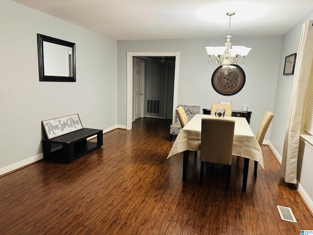 dining area featuring dark hardwood / wood-style floors and a notable chandelier