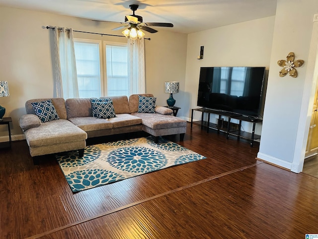 living room featuring dark hardwood / wood-style flooring and ceiling fan