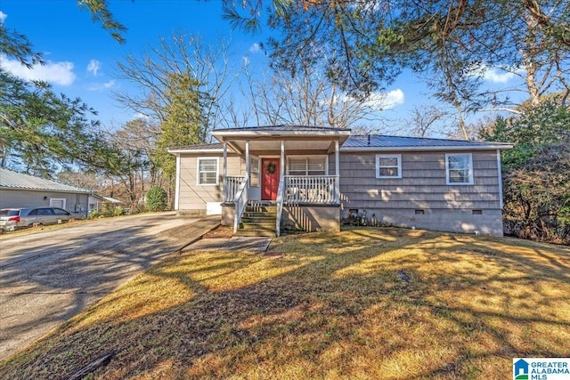 view of front of home with a front yard and covered porch