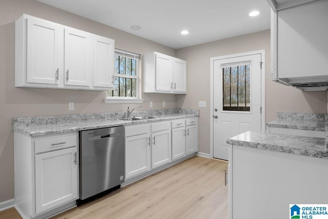 kitchen with white cabinetry, dishwasher, sink, and light hardwood / wood-style flooring