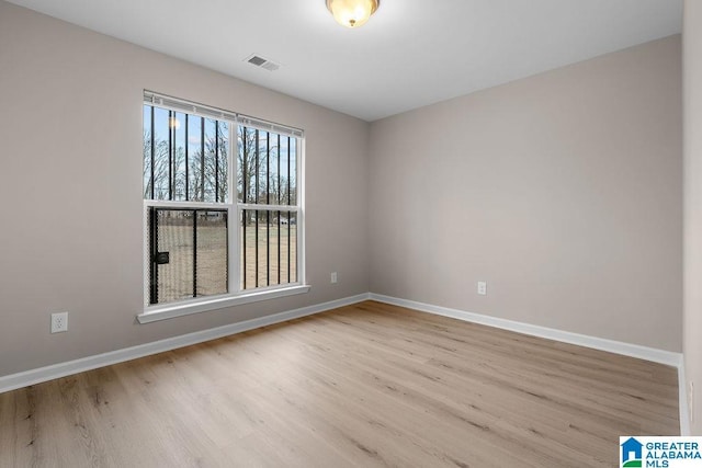 spare room with light hardwood / wood-style flooring