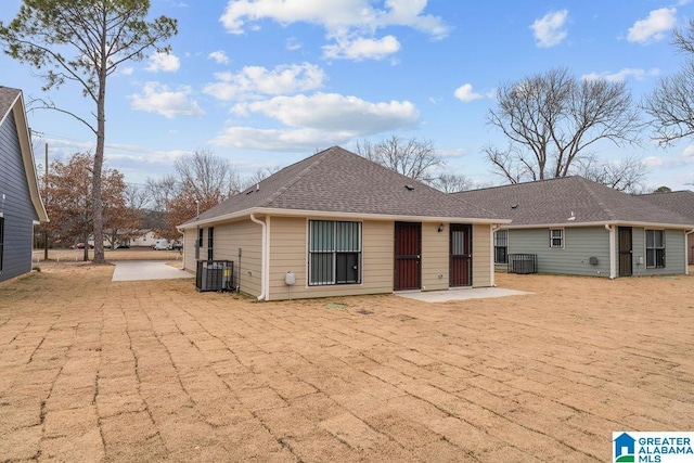 rear view of house featuring cooling unit and a patio