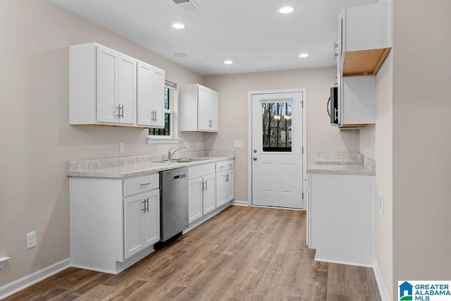 kitchen featuring light hardwood / wood-style floors, dishwasher, sink, and white cabinets