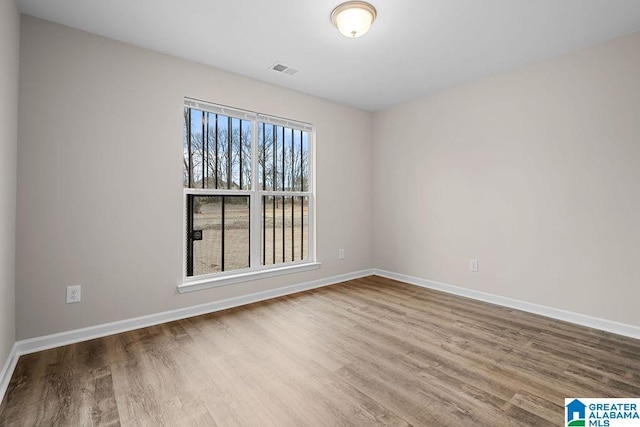 unfurnished room featuring hardwood / wood-style flooring