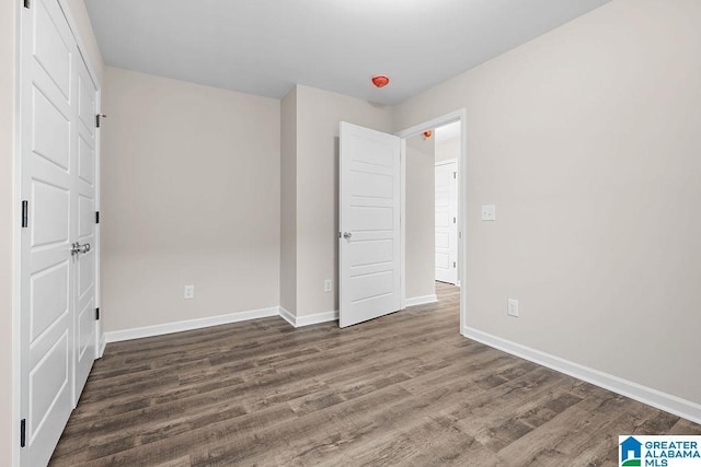 unfurnished bedroom featuring dark hardwood / wood-style flooring