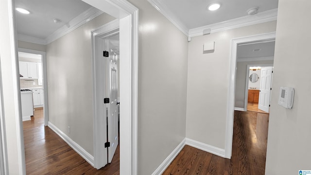 hall with ornamental molding and dark hardwood / wood-style flooring