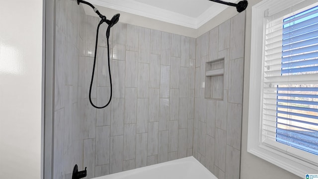 bathroom with tiled shower / bath combo, ornamental molding, and a healthy amount of sunlight