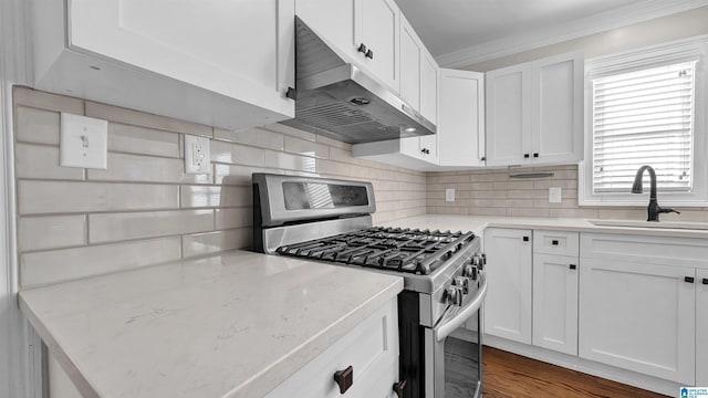 kitchen with backsplash, stainless steel range with gas cooktop, sink, and white cabinets